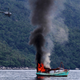 An unmanned Vietnamese fishing boat is blown up and sunk by the Indonesian navy,
